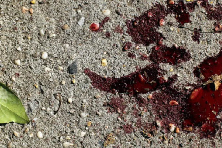 Chão sujo de sangue após crime: o estudante, que era de Campinas e estava com a namorada e dois amigos, questionou o valor da refeição, R$ 19,99, anunciada por R$ 12,99 (Spencer Platt/Getty Images/Getty Images)