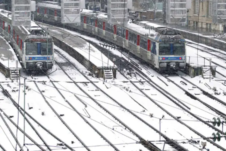 Trens e trilhas coberta de neve na estação ferroviária Gare Saint Lazare, em Paris (Gonzalo Fuentes/Reuters)