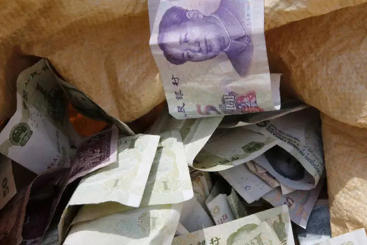 
	Notas de Yuan no saco de um vendedor do mercado de Pequim: resultado mostra que a demanda dom&eacute;stica est&aacute; ganhando a for&ccedil;a necess&aacute;ria para impulsionar a recupera&ccedil;&atilde;o
 (Kim Kyung-Hoon/Reuters)