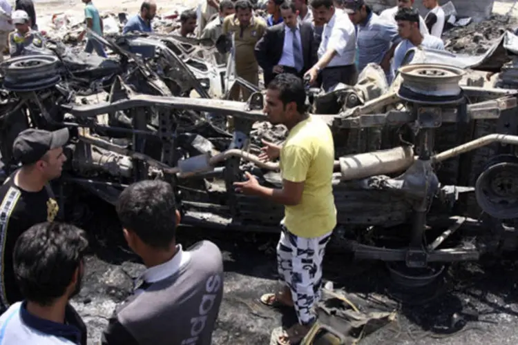 
	Moradores se re&uacute;nem no local de um ataque com carro-bomba em Kerbala, ao sul de Bagd&aacute;, no Iraque: a prov&iacute;ncia com mais v&iacute;timas foi Bagd&aacute;
 (Mushtaq Muhammed/Reuters)