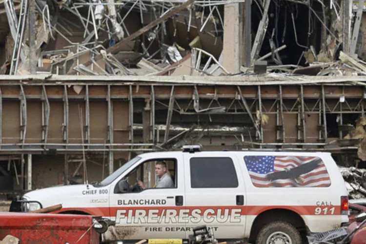 Bombeiro dirige através dos destroços do centro médico da cidade de Moore após a passagem de um tornado, no Estado de Oklahoma (Gene Blevins/Reuters)