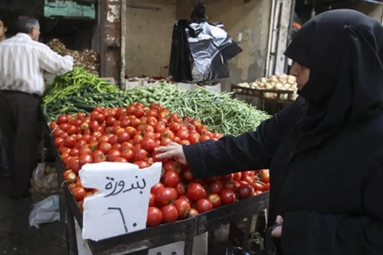 
	Mulher compra vegetais na cidade de Salqin, na S&iacute;ria: fraqueza da libra pode prenunciar uma queda livre se o Banco Central ficar sem d&oacute;lar para proteger a cota&ccedil;&atilde;o
 (Muzaffar Salman/Reuters)