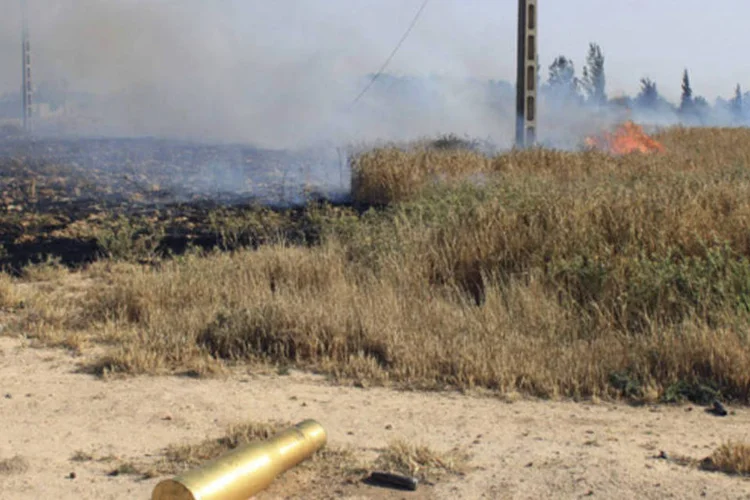 Munição vazia em campo após combate pesado entre Exército Livre da Síria, e forças do Presidente Bashar al-Assad e Hezbollah, em área próxima de Qusair, Síria (Rami Bleible/Reuters)
