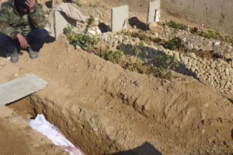 
	Soldado do Ex&eacute;rcito S&iacute;rio Livre lamenta perto da sepultura de colega que morreu em confronto com for&ccedil;as leais ao presidente Bashar al-Assad, na cidade de Qusair, na S&iacute;ria
 (Trad al-Zouhouri/Shaam News Network/Divulgação)