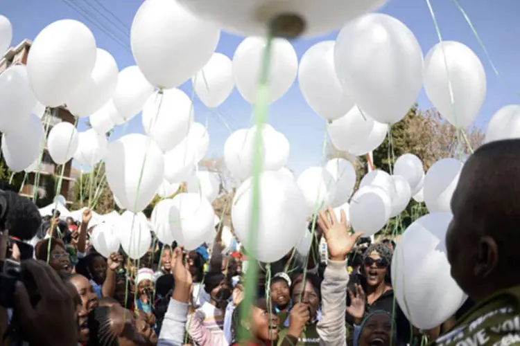 Crianças lançam balões brancos para marcar a chegada do 95º aniversário do líder sul-africano Nelson Mandela, do lado de fora do hospital onde está sendo tratado (Dylan Martinez/Reuters)