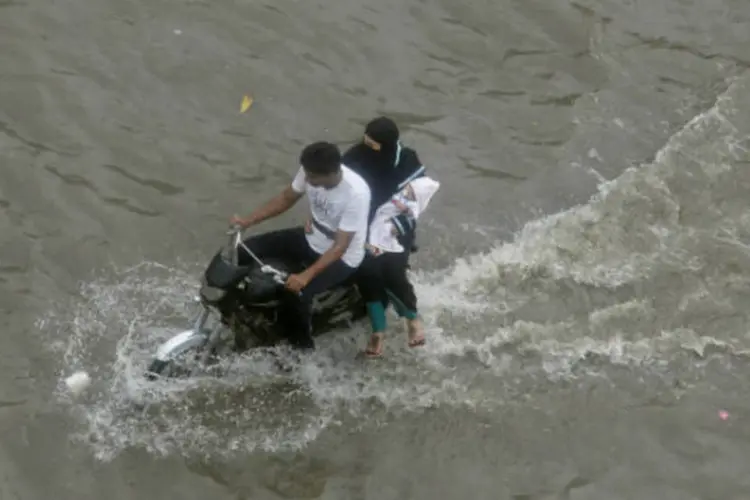 
	Motoqueiro leva mulher e seu filho em rua inundada em Lahore, no Paquist&atilde;o: o pa&iacute;s registra mais de 100 mortes por causa das inunda&ccedil;&otilde;es nas duas &uacute;ltimas semanas
 (Mohsin Raza/AFP)