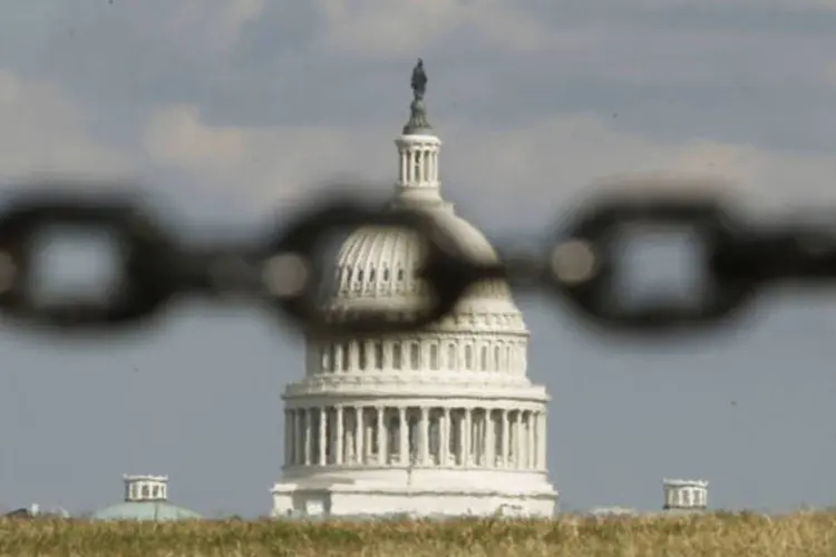 
	Capit&oacute;lio, sede do Congresso dos EUA, &eacute; visto atrav&eacute;s de uma corrente, em Washington:&nbsp;ag&ecirc;ncia de classifica&ccedil;&atilde;o Fitch&nbsp;alertou que poder&aacute; rebaixar a nota do pa&iacute;s
 (Kevin Lamarque/Reuters)