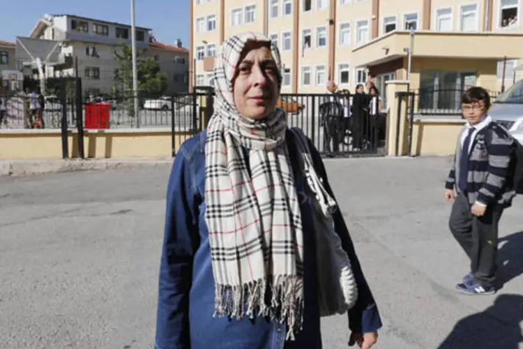 Safiye Ozdemir, 45, em frente a escola onde trabalha como professora, no centro de Ancara, na Turquia (Umit Bektas/Reuters)