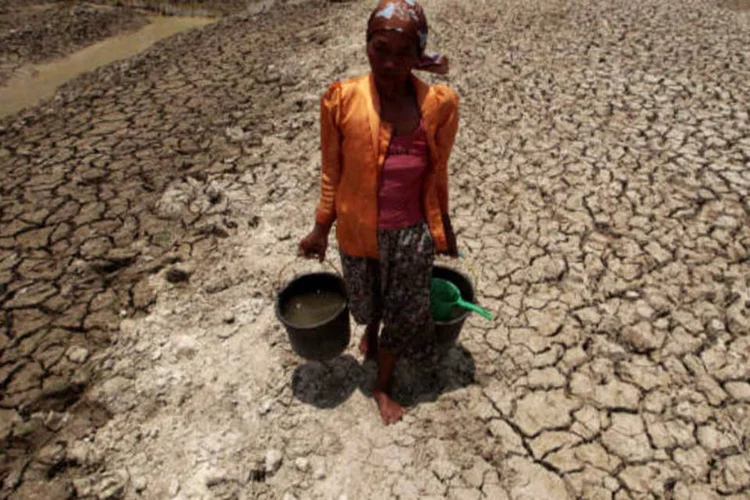 Mulher carrega baldes de água durante a seca de vilarejo na Indonésia (16/10/2013) (REUTERS/Sigit Pamungkas)