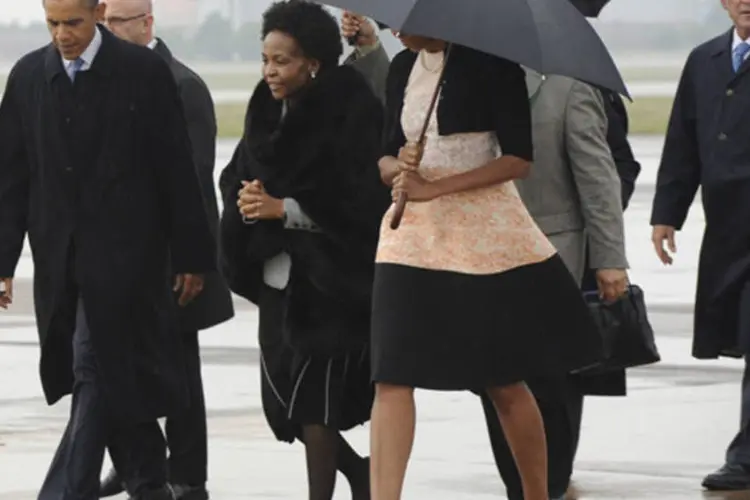 Presidente Barack Obama e o ex-presidente George W. Bush são recebidos por oficias em sua chegada em Pretória, África do Sul (GCIS/Divulgação via Reuters)