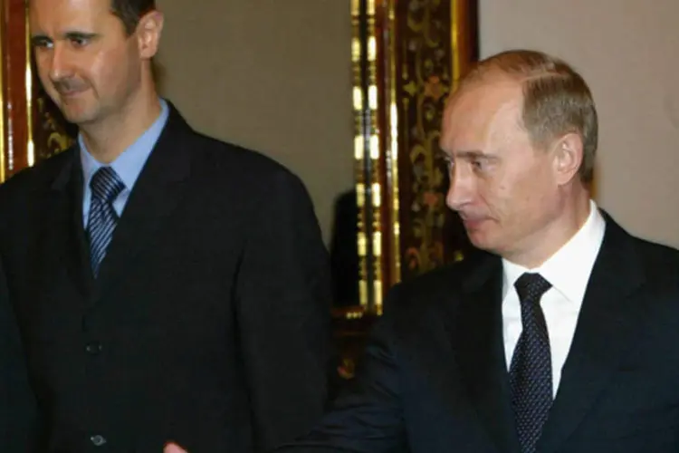 Vladimir Putin recebe o presidente sírio, Bashar al-Assad, durante encontro entre os dois líderes no Kremlin, em janeiro de 2005 (Salah Malkawi/ Getty Images)