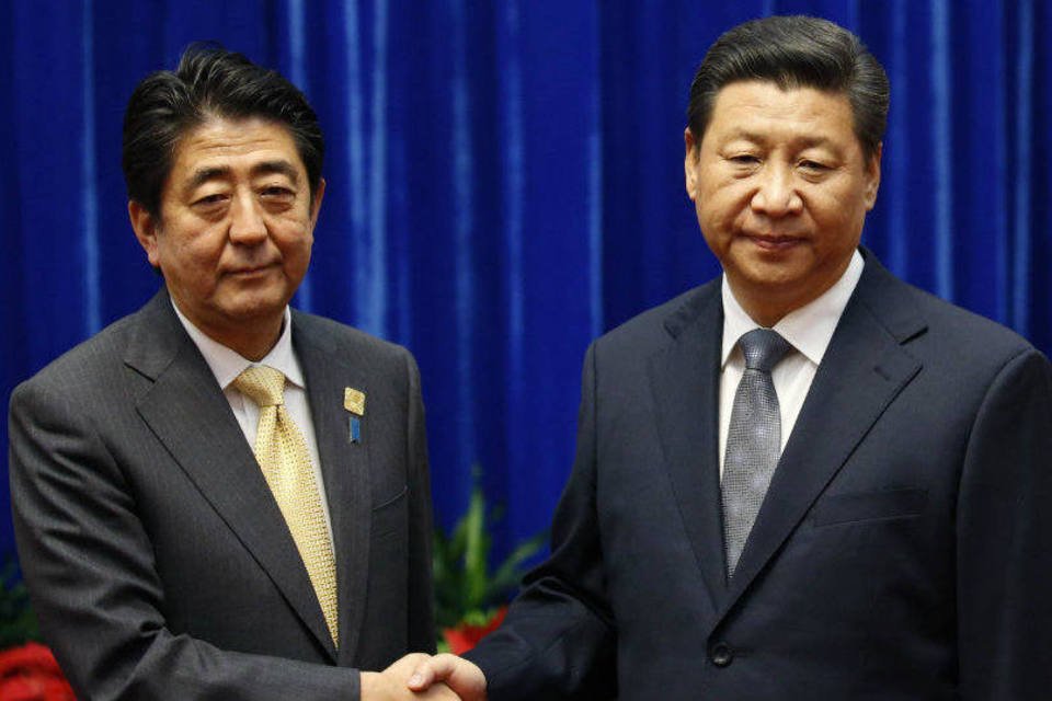 O primeiro-ministro japonês, Shinzo Abe (e), e o presidente chinês, Xi Jinping (Kim Kyung-Hoon/Reuters)