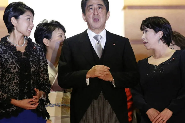 
	Shinzo Abe entre Yuko Obuchi (E) e Sanae Takaichi, novas ministras do governo
 (Toru Hanai/Reuters)