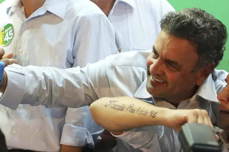 Aécio Neves (PSDB) tira uma foto com um eleitor durante um evento de campanha em São Paulo (Nacho Doce/Reuters)