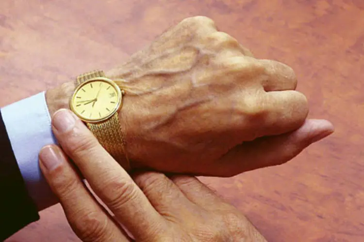 Homem checa as horas em seu relógio (Stock.xchng)