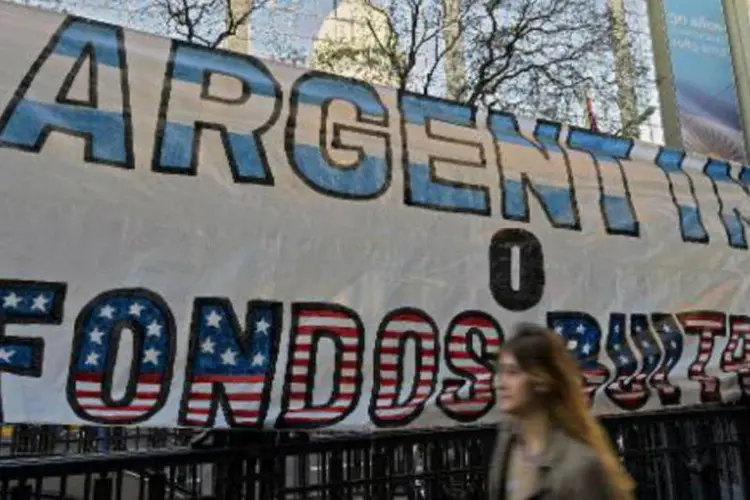 
	&quot;Argentina ou fundos abutres&quot; diz a faixa exposta em frente ao Congresso Nacional, em Buenos Aires: negocia&ccedil;&otilde;es fracassaram na semana
 (Juan Mabromata/AFP)