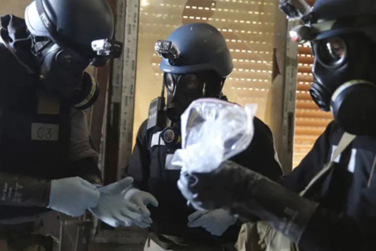 
	Um especialista em armas qu&iacute;micas da ONU segura um saco pl&aacute;stico contendo amostras de um dos locais de um ataque qu&iacute;mico na S&iacute;ria
 (Mohamed Abdullah/Reuters)