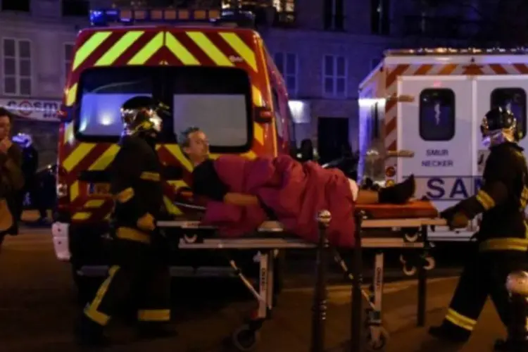 Vítima de ataque em Paris é resgatada, em 13/11/2015 (Dominique Faget/AFP)