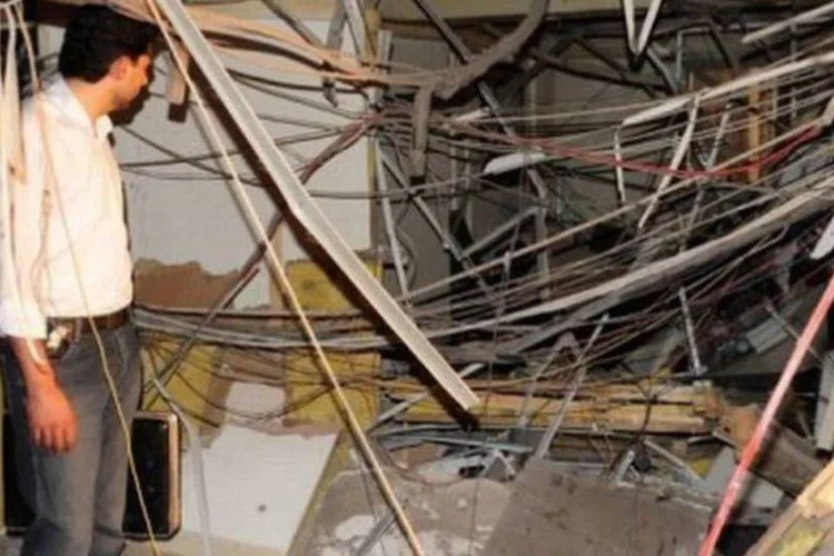Sírio inspeciona prejuízos após explosão na sede da rádio e televisão síria em Damasco (AFP)