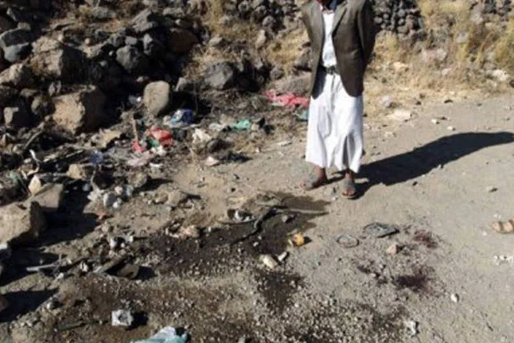 Curiosos observam o local dos assassinatos: Sanaa tem sido palco de muitos assassinatos de policiais e de membros do Exército, atribuídos pelas autoridades à Al-Qaeda (©AFP / Mohammed Huwais)