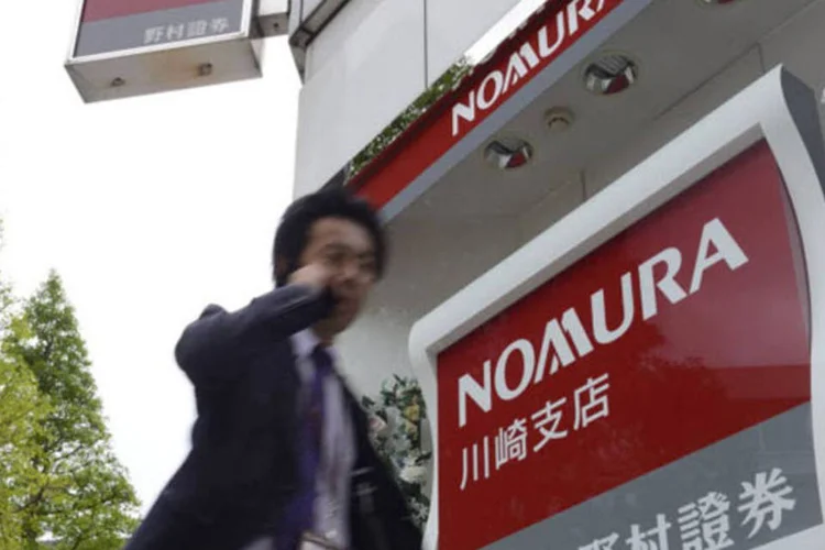 
	Nomura: analistas de pesquisa trabalhando para bancos eram muito brandos com empresas, enquanto que analistas independentes podem ser mais frios e prontos a emitir alertas para vender a&ccedil;&otilde;es
 (Akio Kon/Bloomberg)
