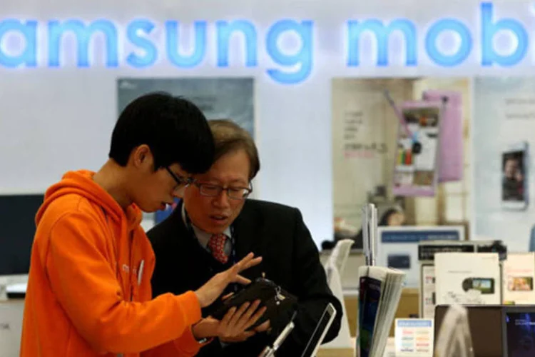 Vendedor ajuda um consumidor em uma loja da Samsung em Seul, na Coreia do Sul (SeongJoon Cho/Bloomberg[)