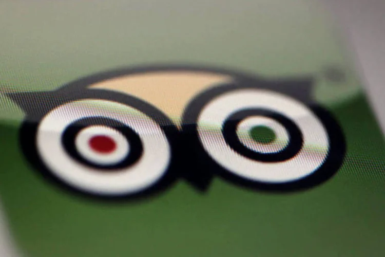 
	Logo do aplicativo TripAdvisor na tela de um iPad: TripAdvisor foi multado em 500 mil euros no ano passado por autoridade italiana
 (Tim Boyle/Bloomberg)