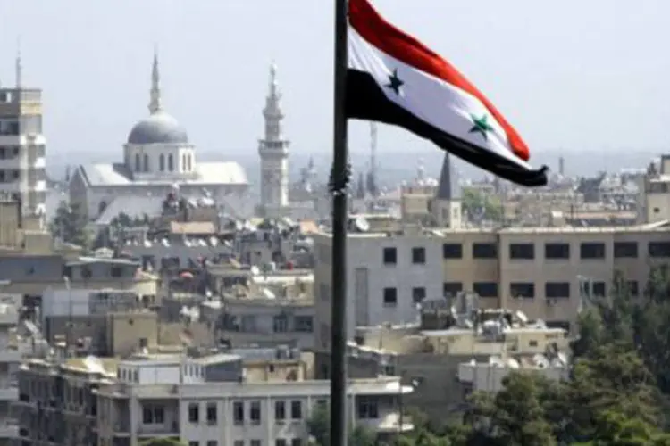 A bandeira síria é vista em Damasco em 20 de setembro
 (Louai Beshara/AFP)