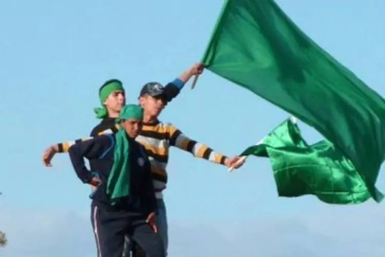 Líbios agitam a bandeira verde, símbolo do governo de Muamar Kadafi (Imed Lamloum/AFP)