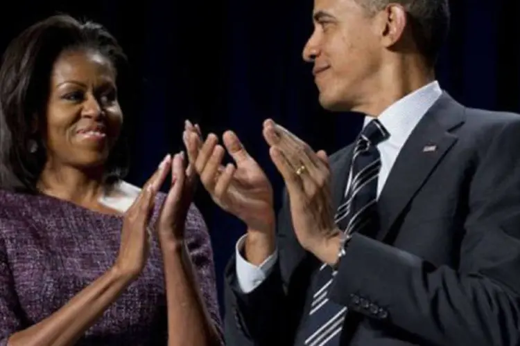 Barack Obama ao lado da primeira-dama Michelle: os repórteres que estavam no local afirmaram que Michelle sinalizou que "não" com a cabeça (Saul Loeb/AFP)