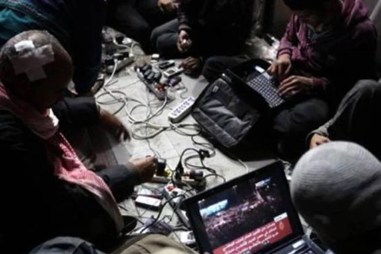 Blogueiros contrários ao governo trabalham em seus computadores na Praça Tahrir, no Egito, durante protesto contra Hosni Mubarak (AFP/Arquivo / Patrick Baz)