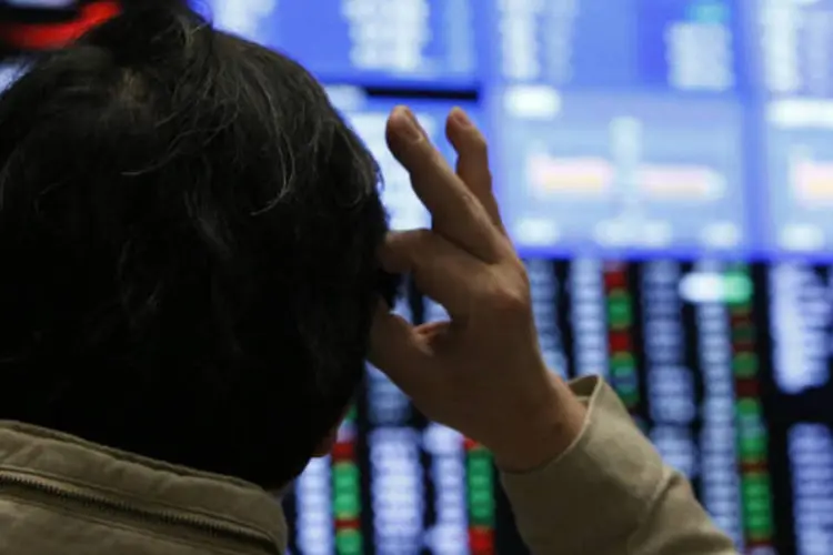 
	Bolsa de T&oacute;quio: &iacute;ndice japon&ecirc;s Nikkei eliminou as perdas iniciais e fechou em alta de 0,20 por cento, enquanto o mercado de Hong Kong ganhou 0,26 por cento
 (REUTERS/Yuya Shino)