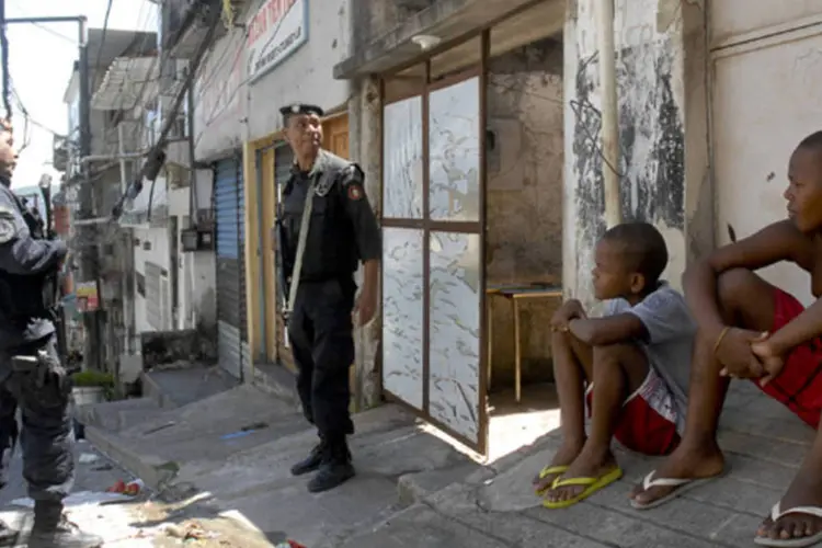 
	Moradores da Favela do Jacarezinho observam policiais, no Rio de Janeiro
 (Tania Rêgo/ABr)