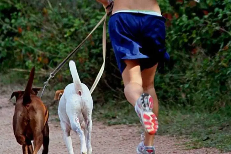 Mulher Correndo com Dois Cachorros (Stock.XCHNG)