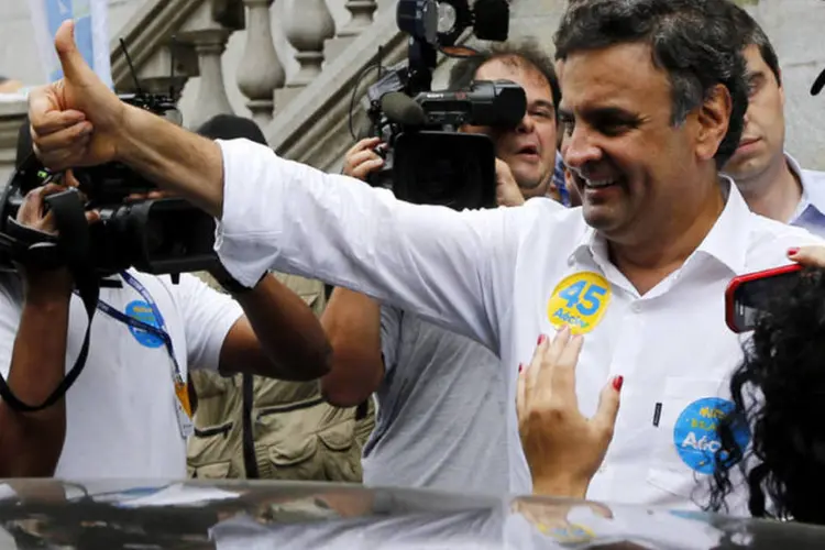 O candidato do PSDB à Presidência, Aécio Neves, faz sinal de positivo em campanha na cidade de Santos (Paulo Whitaker/Reuters)