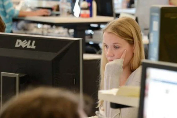 Mulher trabalha em frente ao computador: Elas passam mais tempo online do que os homens (Robyn Beck/AFP)