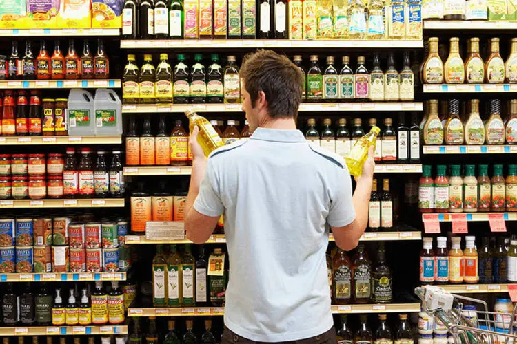 
	Consumidor compara produtos no supermercado
 (Noel Hendrickson/Thinkstock)