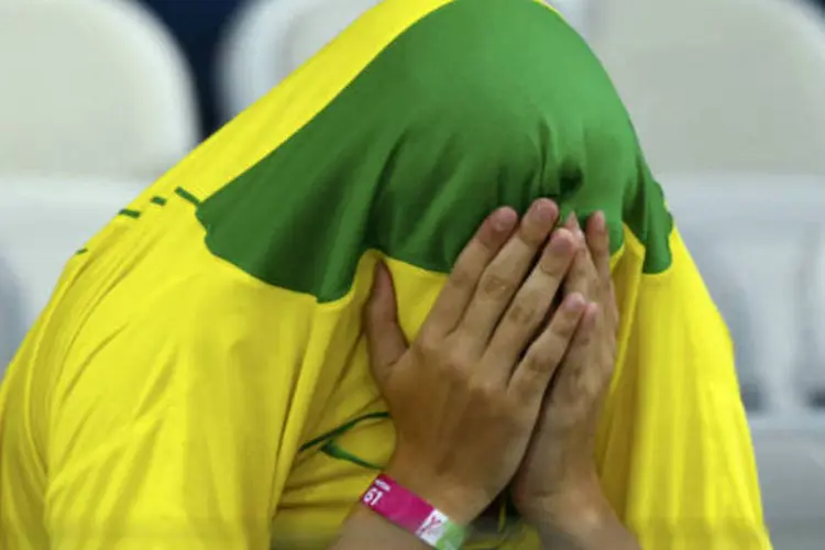 Torcedor brasileiro se esconde após derrota do Brasil para a Alemanha pela semifinal da Copa do Mundo (REUTERS/Ruben Sprich)