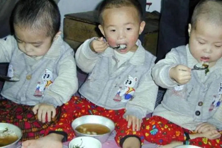 Bebês se alimentam em um orfanato em na cidade de Chongjin: as crianças de menos de cinco anos são os principais alvos do programa da UE (Gerald Bourke/AFP)