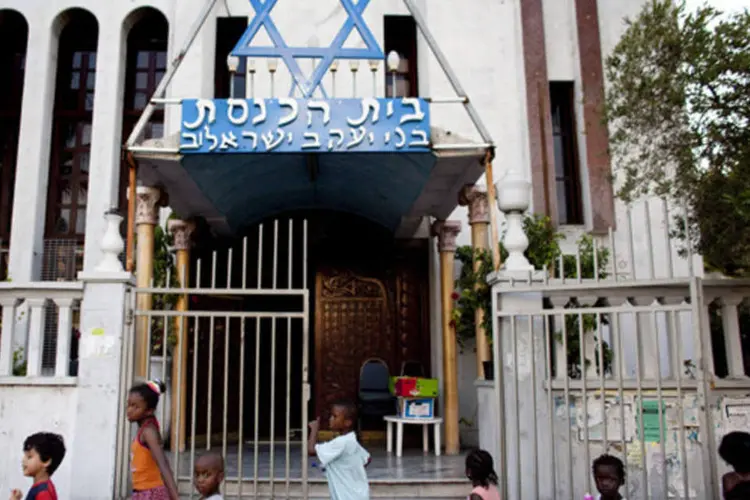 Crianças imigrantes passam por sinagoga em Tel Aviv, Israel: para Yishai, somente os considerados refugiados deveriam receber permissão para ficar no país
 (Uriel Sinai/Getty Images)