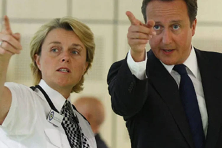 Policial e David Cameron: "a um ano das Olimpíadas, precisamos mostrar que o Reino Unido não destrói, mas cria; que não abandona, mas resiste" (Jeff J Mitchell - WPA Pool/Getty Images)