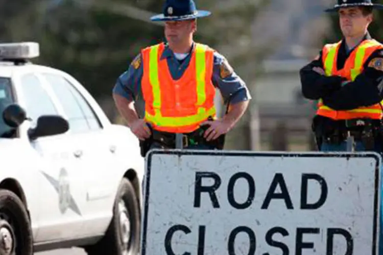Policiais guardam uma rua interditada próximo a Oso, em Washington, a 3 km de um deslizamento que matou 14 pessoas  (Paul Joseph Brown/AFP)