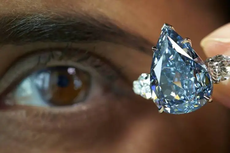 Funcionária da Christie's posa com "The Blue", maior diamante azul do mundo, durante leilão em Genebra, na Suíca (Denis Balibouse/Reuters)