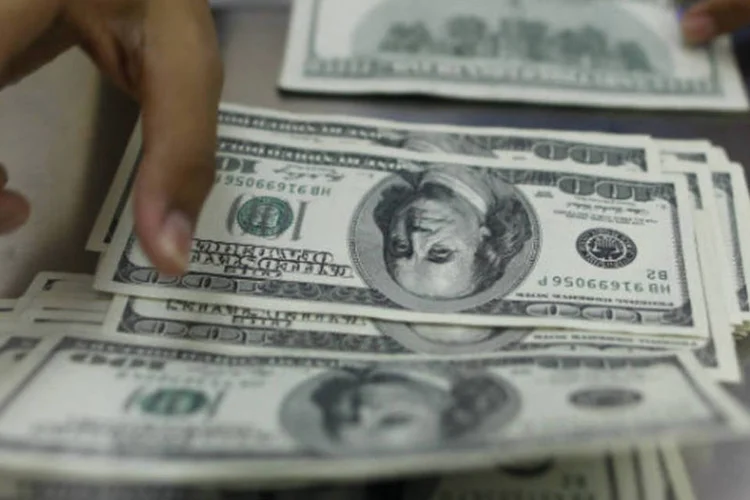 
	Pessoa manipula notas de d&oacute;lar: os 20 mil contratos ofertados, com vencimento em 2 de dezembro deste ano, foram negociados. No total, foram negociados R$ 994,9 milh&otilde;es
 (REUTERS/Soe Zeya Tun)