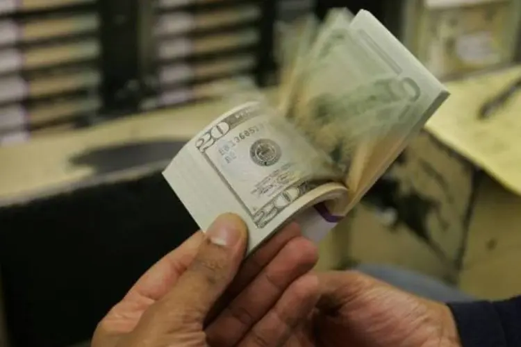Dólares em movimento (Joe Raedle/Getty Images)