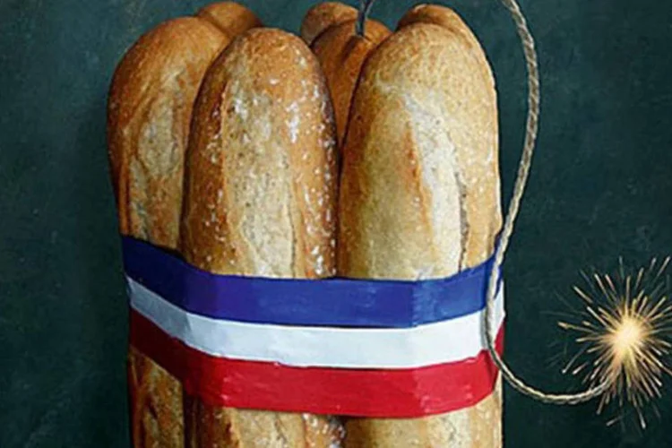 
	Capa mostra sete p&atilde;es &quot;baguete&quot; unidos por uma fita com as tr&ecirc;s cores da bandeira francesa, com um pavio aceso saindo do centro
 (Reprodução)