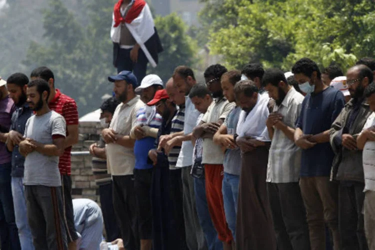 Membros da Irmandade Mulçumana e apoiadores do presidente deposto do Egito Mohamed Mursi rezam em frente ao quartel general da Guarda Republicana, no Cairo (Amr Abdallah Dalsh/Reuters)