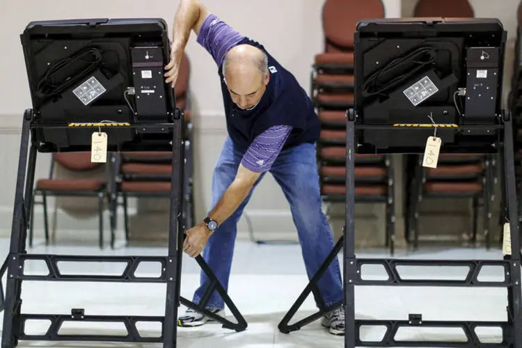 Voluntário das eleições arruma uma sessão eleitoral na Harrison United Methodist Church, na Carolina do Norte (Chris Keane/Reuters)