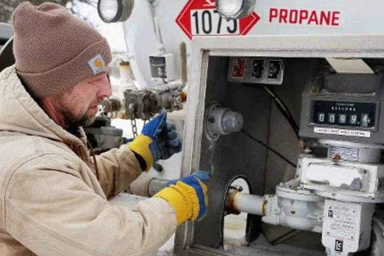 Homem se abastece de gás propano para aquecimento de casa: OMS estabeleceu pela primeira vez limites de emissão de gases e partículas para os aparelhos de cozinha, aquecimento e iluminação (Scott Olson/AFP)