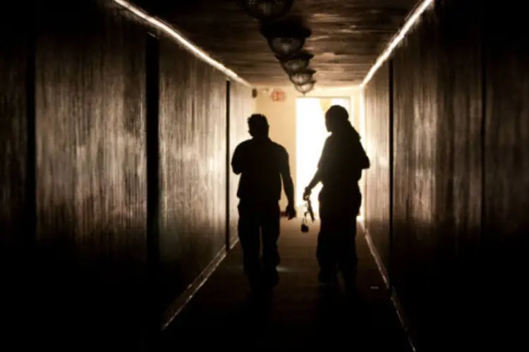 Funcionários caminham por prédio sem luz nos Estados Unidos (Allison Shelley / Getty Images)